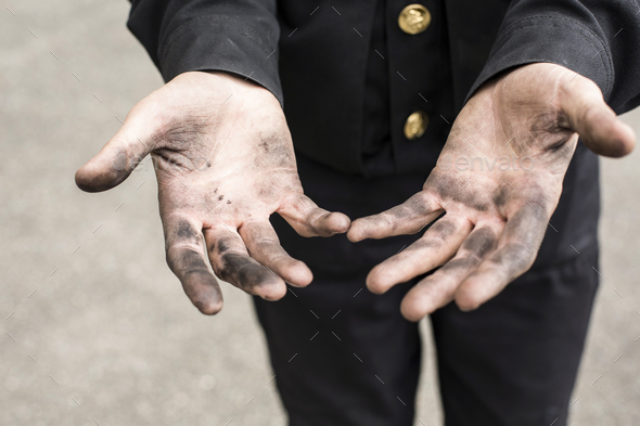 Close-up of dirty hands of a chimney sweep
