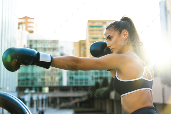 Sportive young woman boxing in the city Stock Photo by westend61 ...