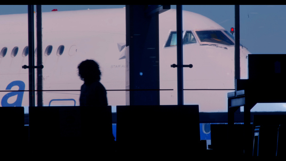People Silhouettes At An Airport