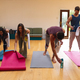 Multiracial men and women arranging exercise mats on hardwood floor in yoga studio - PhotoDune Item for Sale