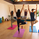Male instructor teaching yoga pose to multiracial man and women in yoga studio - PhotoDune Item for Sale