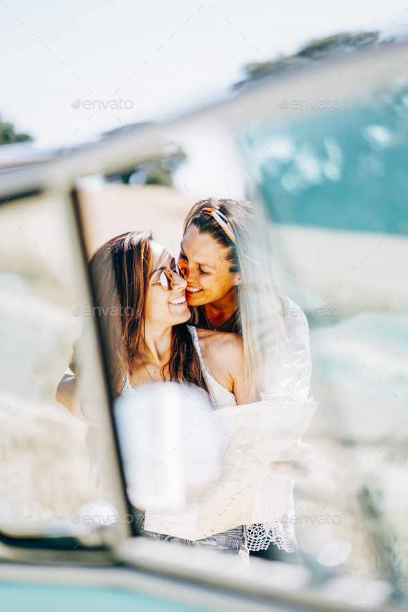 Lesbian Couple Doing A Road Trip Kissing And Embracing In Nature Stock