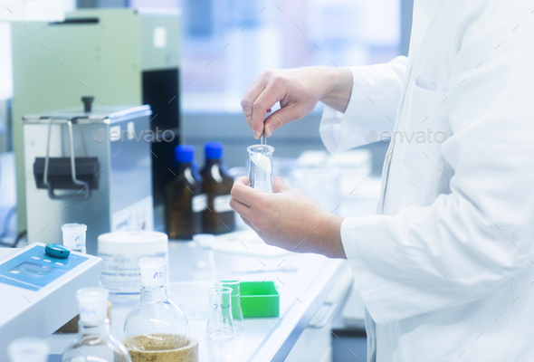 Lab technician experimenting in lab - Stock Photo - Images