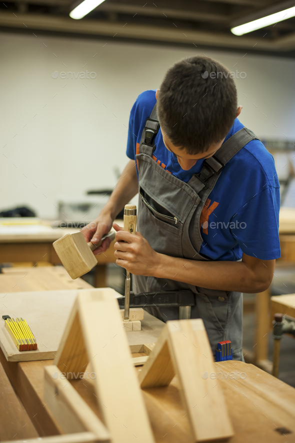 Vocational school student working in a carpenter\'s workshop