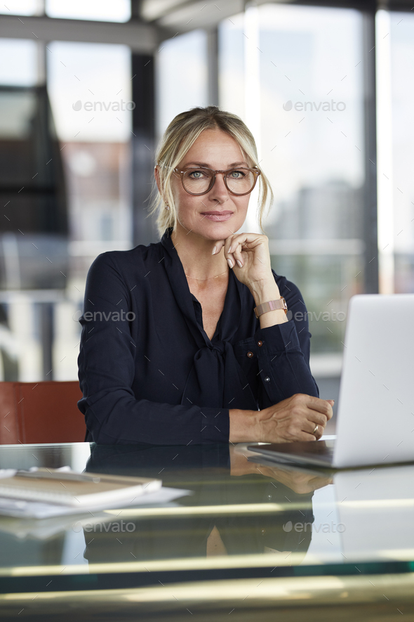 Businesswoman working in office, using laptop - Stock Photo - Images
