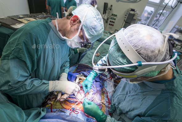 Heart surgeons during a heart valve operation