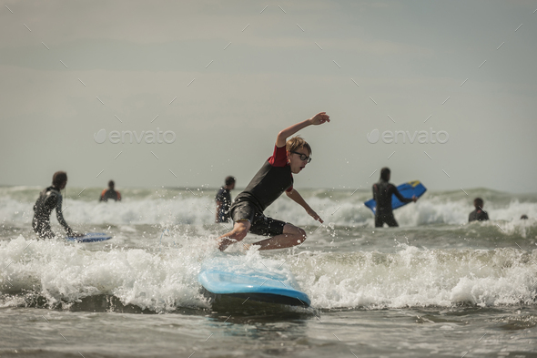 Boy surfboarding - Stock Photo - Images