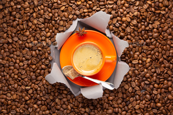 Cup of coffee and beans in torn paper. Coffee bean and espresso - Stock Photo - Images
