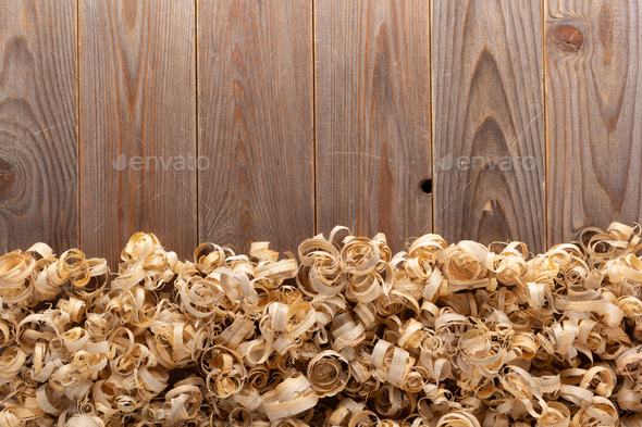 Wood shavings at table background. Wooden shaving on old plank board - Stock Photo - Images