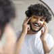 Portrait of indian man applying eye patches on his face and looking at mirror at bathroom - PhotoDune Item for Sale