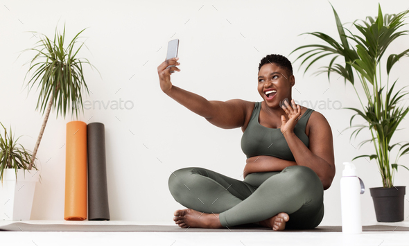 happy pretty chubby black lady taking selfie while doing workout Stock  Photo by Prostock-studio