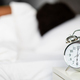 Alarm on bedside over unrecognizable sleeping black lady - PhotoDune Item for Sale
