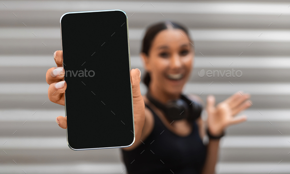 Best App. Excited Sporty Woman Showing Smartphone With Black Screen At Camera - Stock Photo - Images