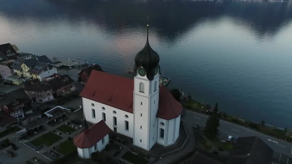 Aerial video of traditional Swiss village along Lake Lucerne, Switzerland. alt