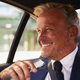 Portrait Of Mature Businessman Holding Mobile Phone In Back Of Taxi Or Car - PhotoDune Item for Sale