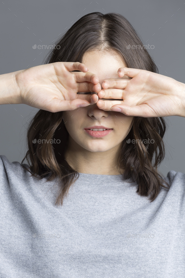 Portrait of brunette young woman, see no evil