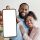 Online Offer. Happy black couple demonstrating big smartphone with blank white screen - PhotoDune Item for Sale