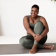 Positive african american lady plus size sitting on yoga mat - PhotoDune Item for Sale
