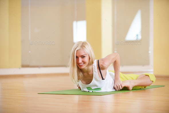 Beautiful sporty fit yogi woman practices yoga asana Bhekasana - frog pose in the fitness room