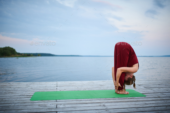 Beautiful young woman practices yoga