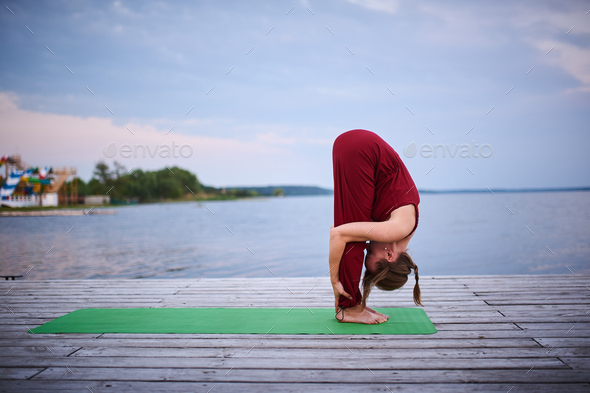 Beautiful young woman practices yoga