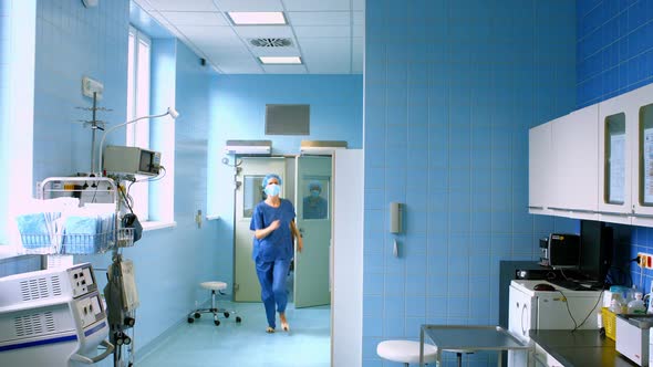 Doctor and nurse running in passageway of hospital alt
