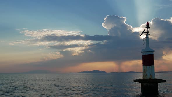 Sunset in Mesologgi Greece. Boat view of the sunset behind clouds and sea horizon. alt
