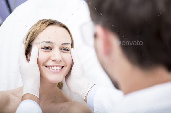 Aesthetic surgery, doctor looking at woman