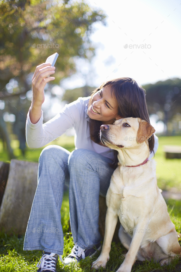Woman taking a selfie with her dog - Stock Photo - Images
