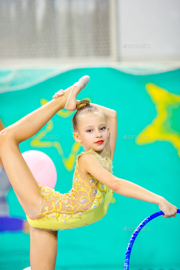 Little beautiful gymnast in competitions of rhythmic gymnastics