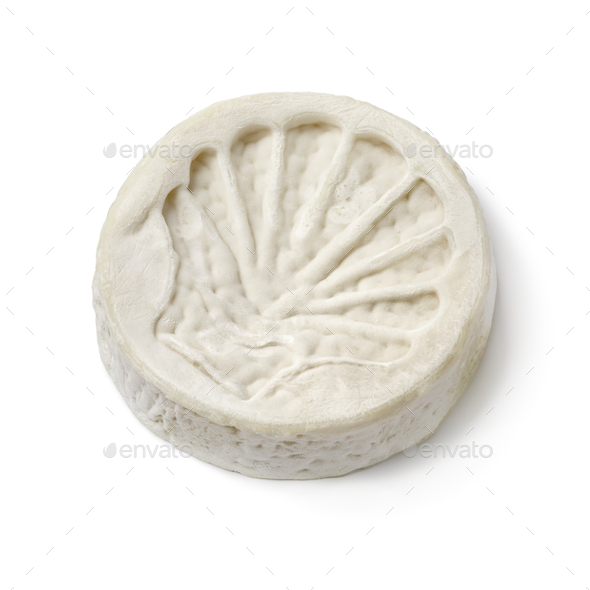 Single piece of French le Compostelle goats cheese close up on white background - Stock Photo - Images