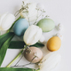 Happy Easter! Stylish Easter eggs and tulips on rustic white wooden background - PhotoDune Item for Sale
