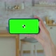 Pretty Girl Making Video Call on Smartphone. Woman at Home Uses Green Mock-up Screen Smartphone - VideoHive Item for Sale