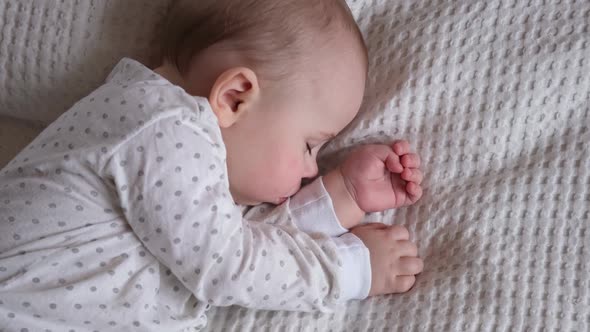 Peaceful Adorable Baby Sleeping on His Bed in a Room at Home alt