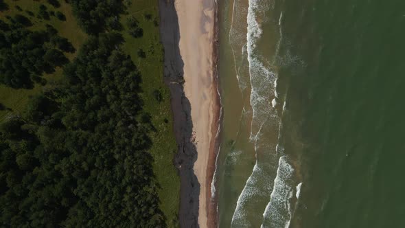 Top View: Beautiful Turquoise Baltic Sea with Waves and Sand Cliff alt