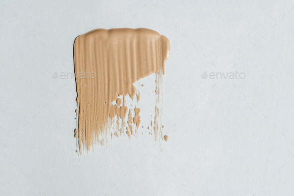 Foundation cream exture on a white background.