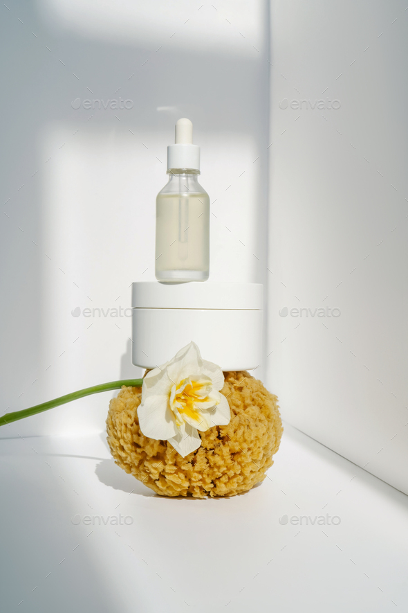 Cream and natural sea sponge on a light background.