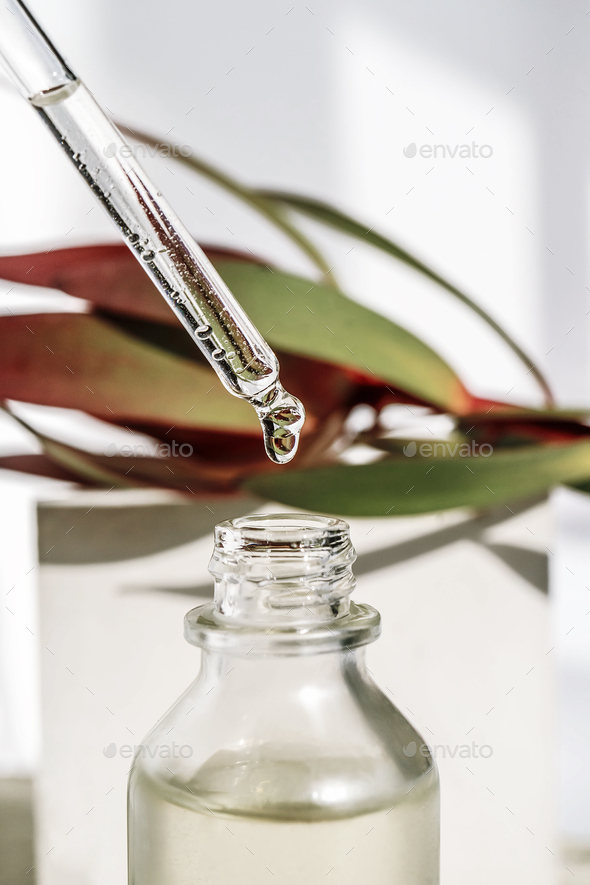 A drop of cosmetic oil falls from the pipette