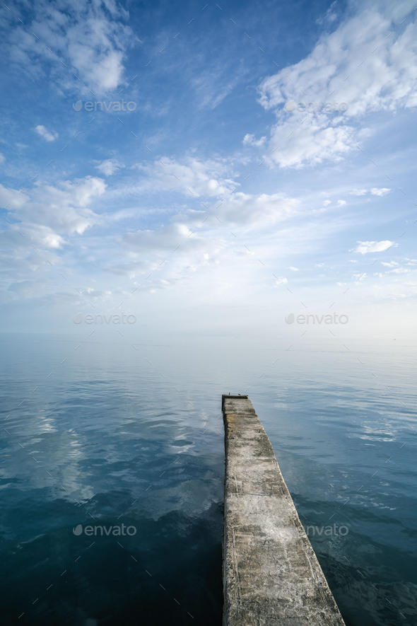 Buna or pier, stretching into the distance between the sky and the sea. - Stock Photo - Images