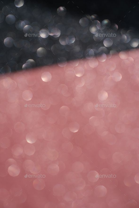 Black and pink abstract glitter background with shiny bokeh