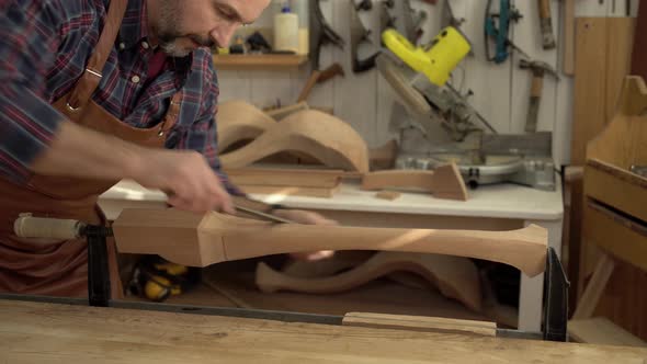 Carpenter Polishes Cabrioli Leg in his Workshop