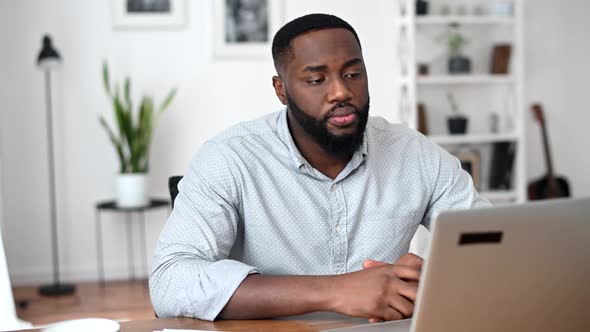 An African Guy Is Using Laptop for Video Call alt