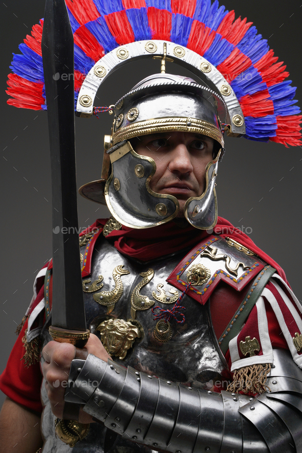 Combative Roman Centurion Dressed In Armor Holding Gladius Stock Photo 