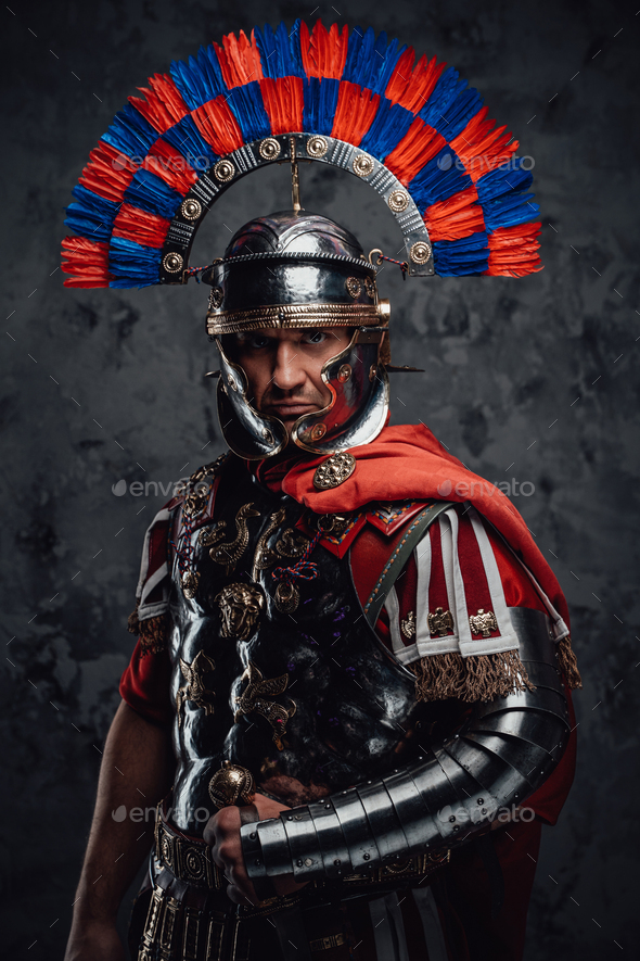 Serious legionnaire with gladius posing against dark background Stock ...