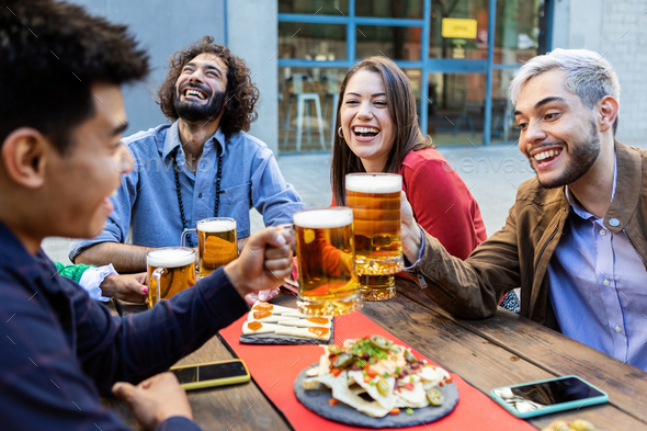 Group of hipster friends enjoying drink at bar terrace - Stock Photo - Images