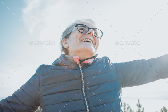 Close up portrait of a super happy smiling old woman during a walk, doing exercise and activities