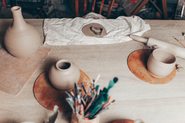 Pottery creative mess on the table. Clay master\'s workplace