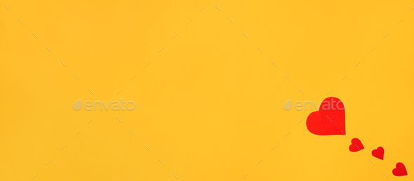 Hearts on a yellow background flat lay. Minimalistic banner copy space. Romantic background