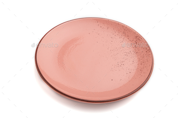 Empty pink dotted ceramic plate isolated on white background. Side view ...