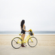 Woman Standing With Bicycle At Beach Against Clear Sky - PhotoDune Item for Sale